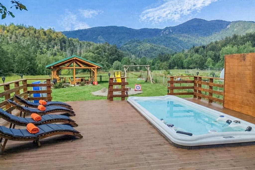 a patio with a pool and chairs and a playground at House Villa Ursus in Gerovo