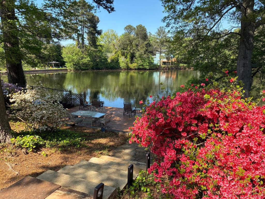 a view of a lake with pink flowers at Lakefront Serenity in Marietta