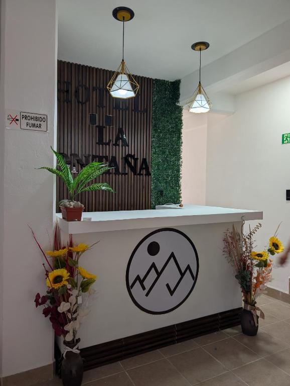a counter in a room with flowers and plants at Hotel de la Montaña in Huautla de Jiménez