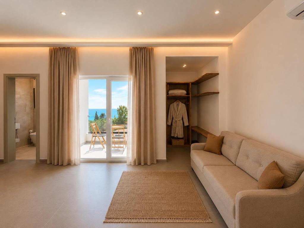 a living room with a couch and a sliding glass door at Domi Drymades in Dhërmi