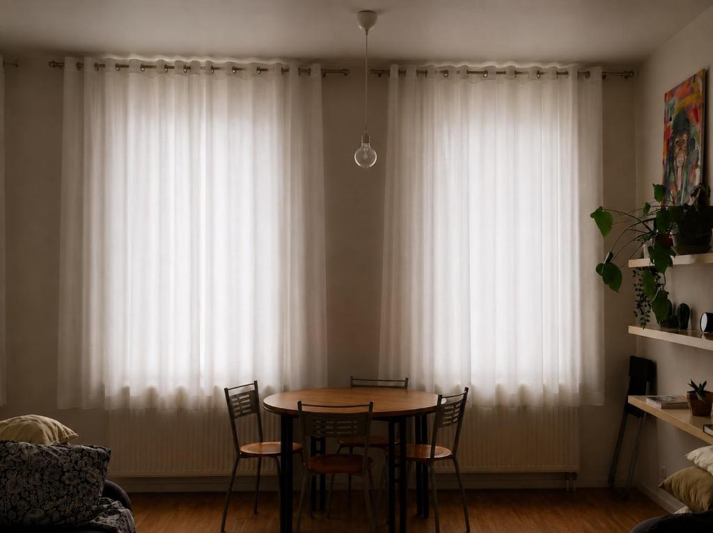 a table and chairs in a room with white curtains at Central Hub in Brussels