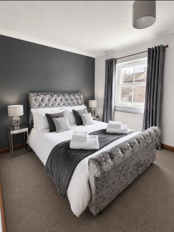 a large bedroom with a large bed and a window at 11 Netherby Street in Longtown