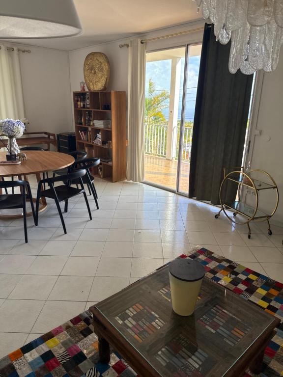 a living room with a table and a dining room at Maison cosy in Saint-Claude