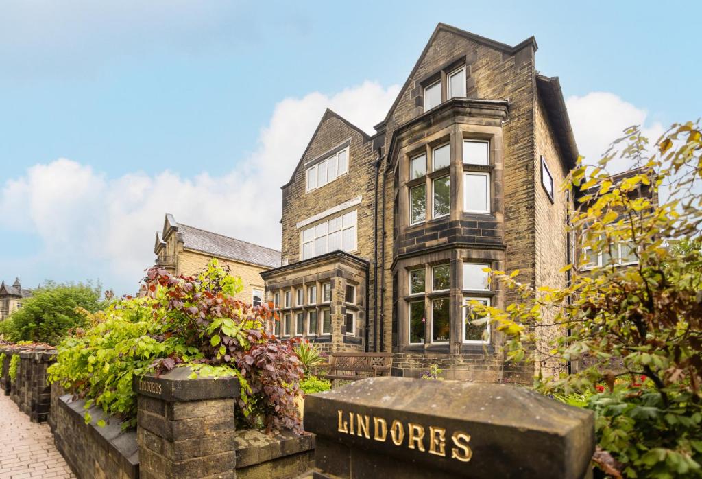 an old house with a sign in front of it at Lindores Bed & Breakfast in Todmorden