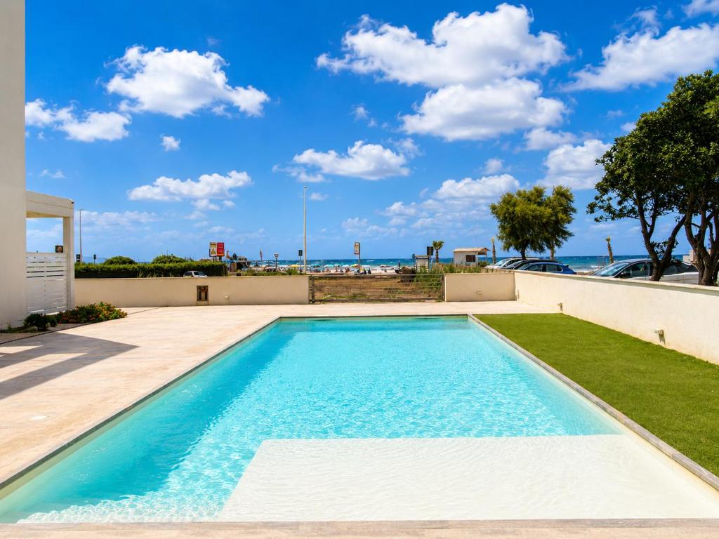 a swimming pool with a view of the ocean at Sea & Pool Apartment in Casa Santa