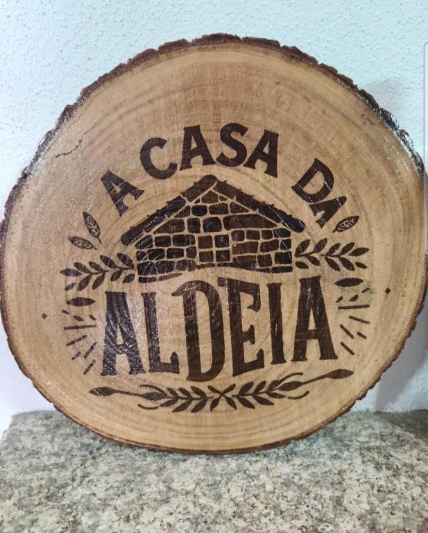 a wooden sign with the name of albia at A Casa da Aldeia 1 Belmonte in Gaia