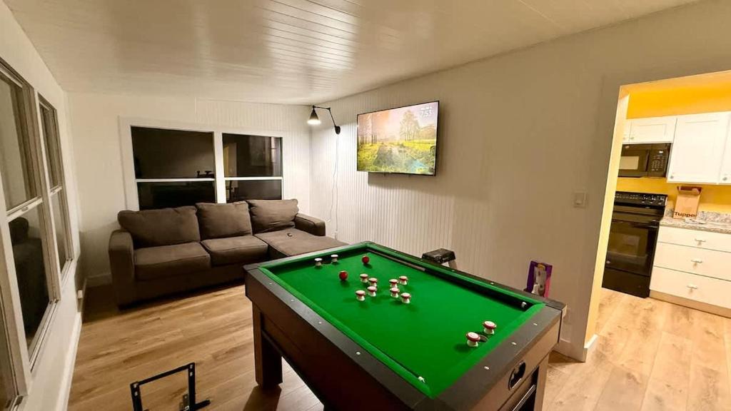 a living room with a pool table in it at Charming Citrus in Inverness