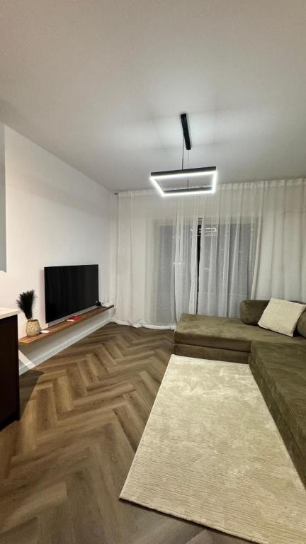 a living room with a couch and a flat screen tv at Mar'al Mar Luxury Escape in Himare