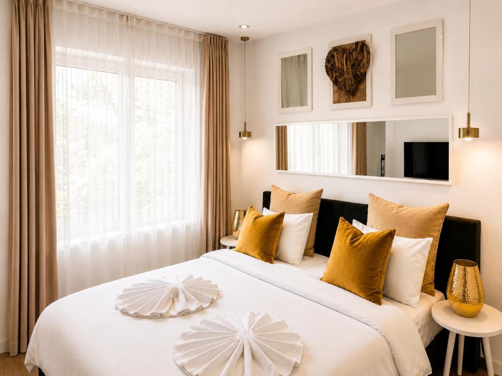 a bedroom with a large bed with yellow and white pillows at Metropole Apartments Romana Square in Bucharest