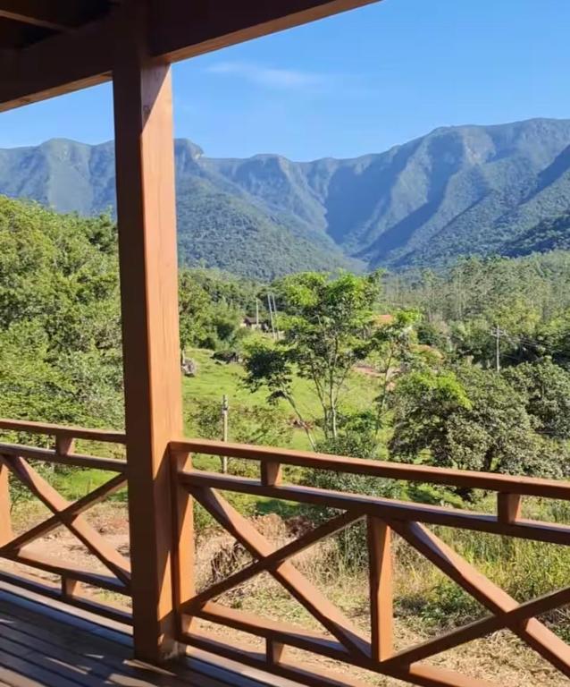 a view from the balcony of a house with mountains in the background at Chalé Vale das Montanhas in Timbe do Sul