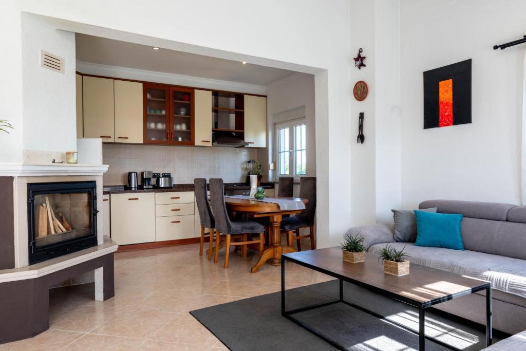 a living room with a couch a table and a kitchen at Apartman Ika Umag in Umag