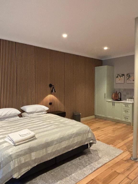 a bedroom with a large bed and a wooden floor at Gala 1 - The Old Coolstore in Merricks North