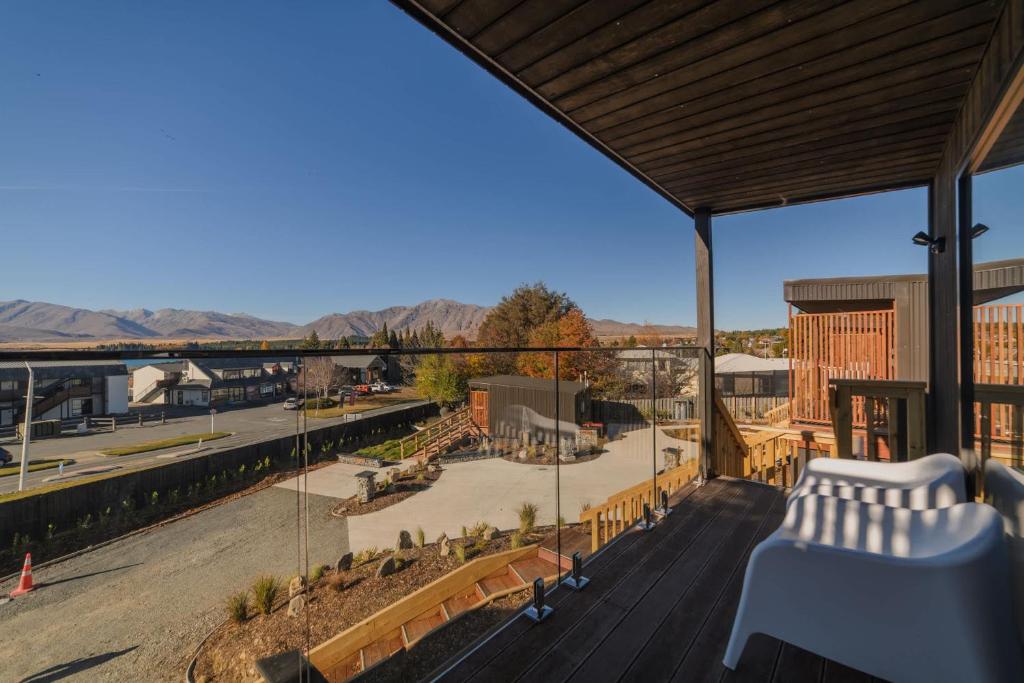 a balcony with a view of a street and mountains at Aurora Vista - Ohana in Lake Tekapo