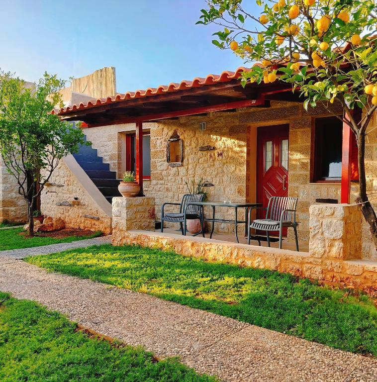 a patio of a house with a table and chairs at Georges Houses Mani in Riglia
