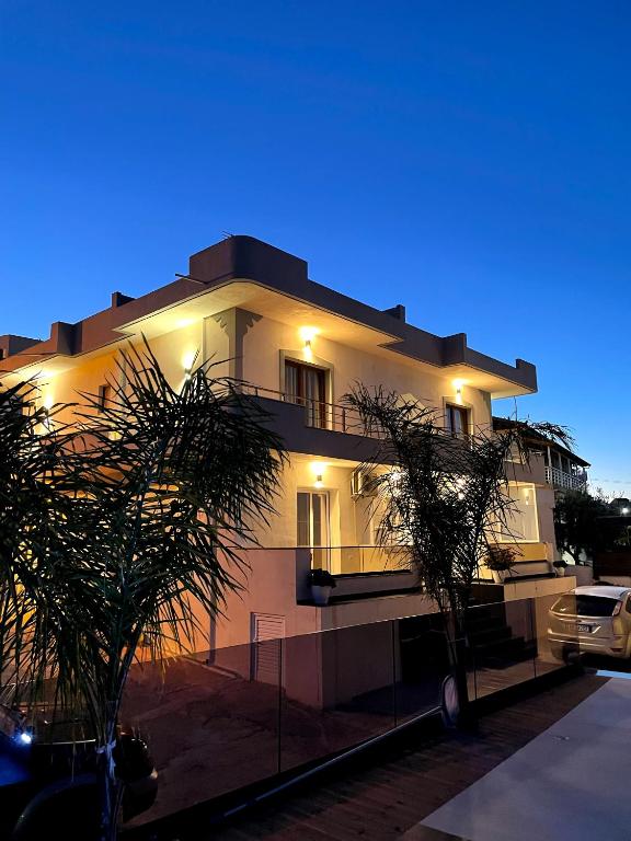 a white building with lights on the side of it at Villa LeoZeka in Ksamil