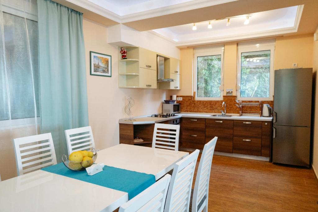 a kitchen with a table and chairs and a refrigerator at Blue Horizon Villa DV in Dobra Voda
