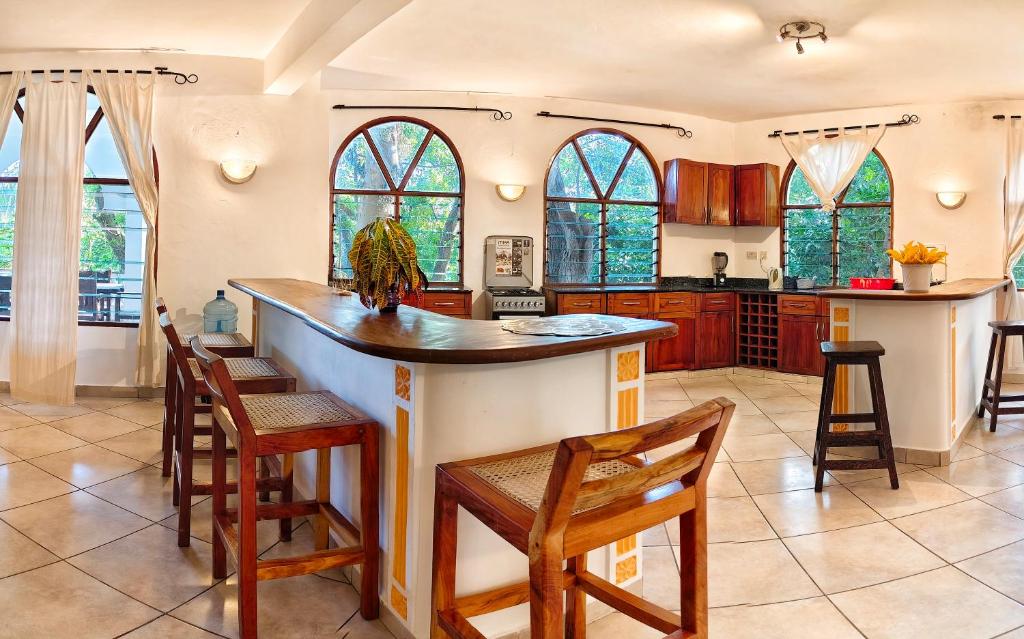 a kitchen with a large island in a kitchen with wooden cabinets at Penety Villa in Shanzu