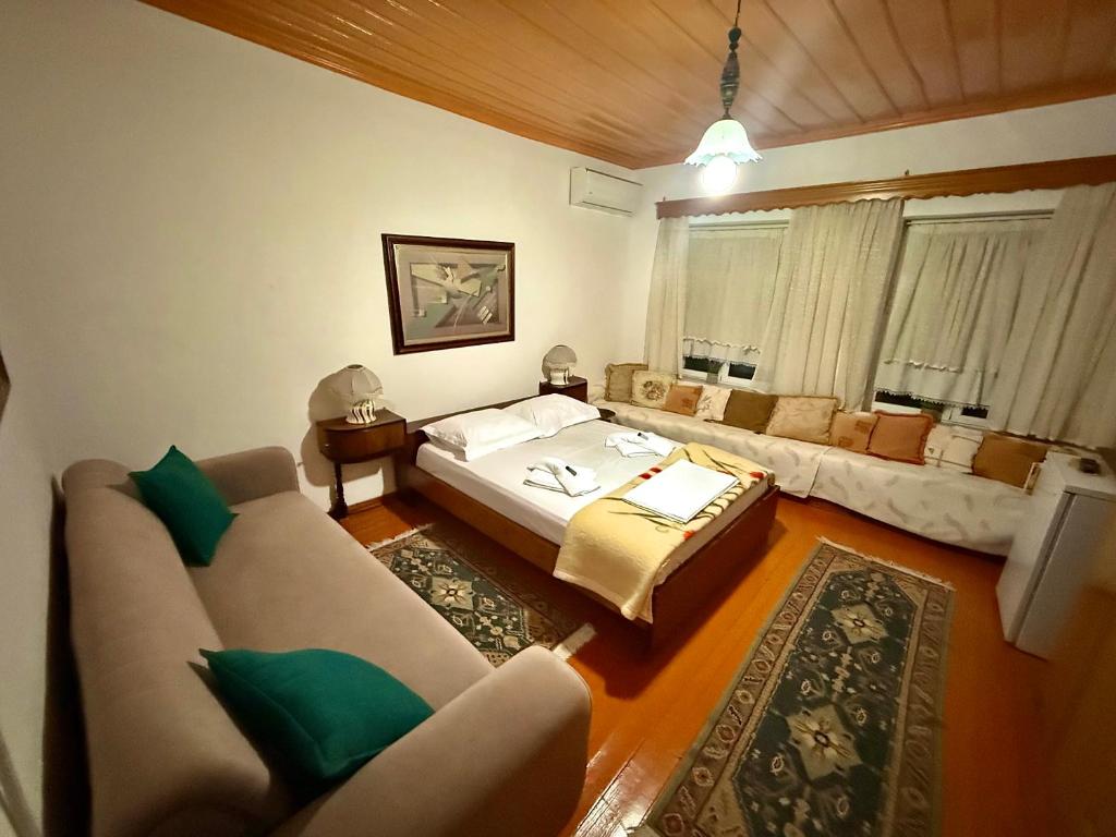 a living room with a bed and a couch at Grandpas House in Gjirokastër