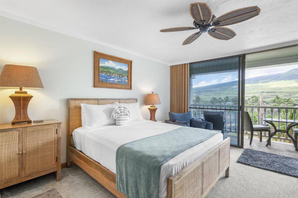 a bedroom with a bed and a balcony at Lahaina Shores #532 in Lahaina