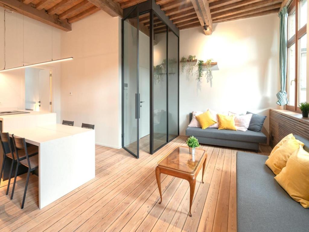 a kitchen and living room with a couch and a table at Stylish Duplex for 6 in Antwerp in Antwerp