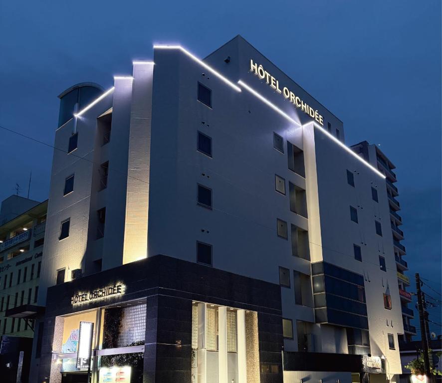 a building with a sign on the side of it at Hotel Orchid (Adult only) in Kurashiki