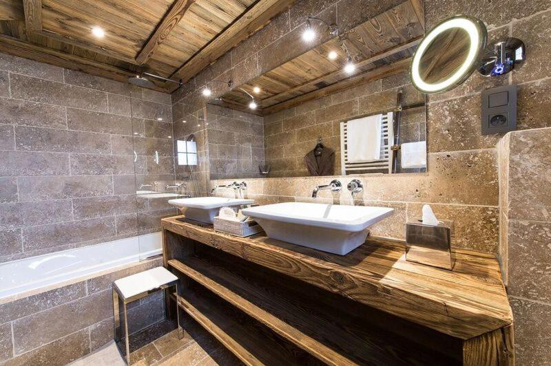 a large bathroom with two sinks and a tub at Le Chalet Blanc in Megève