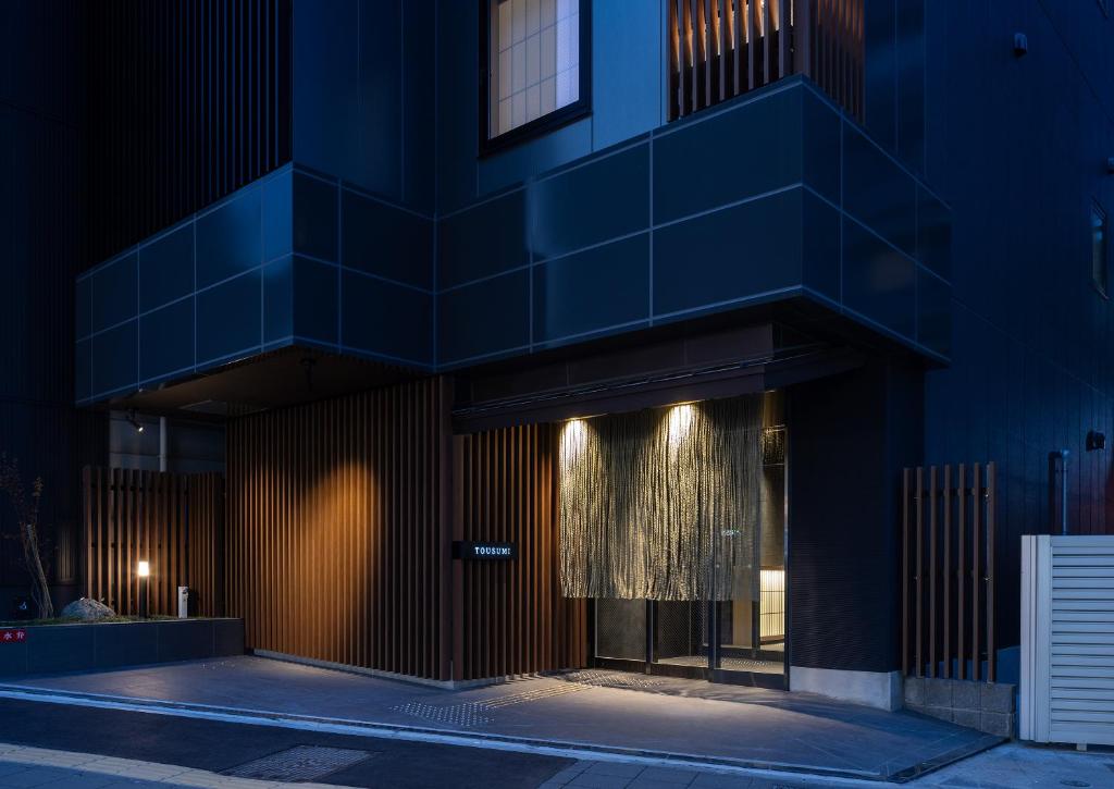 a building with a blue facade at night at Tousumi in Fukuoka