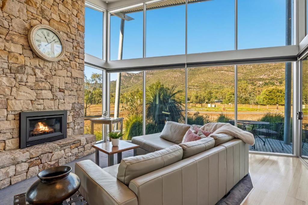 a living room with a couch and a fireplace at Bushland in Halls Gap