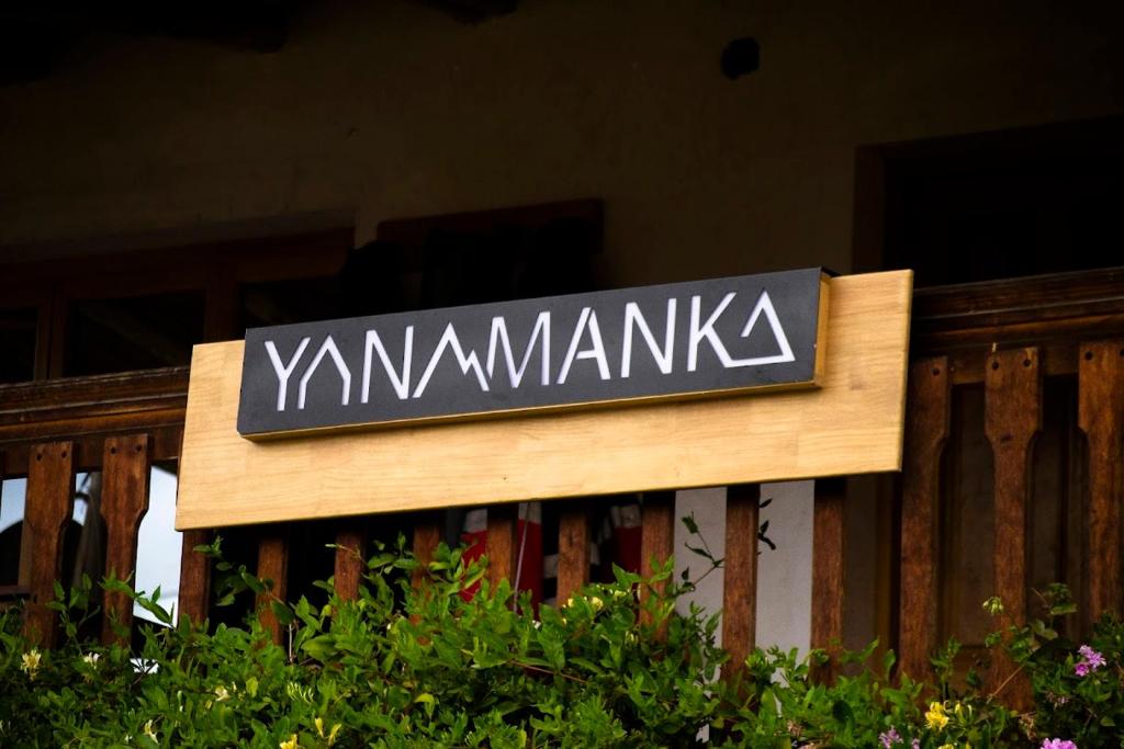 a sign that says yamazakika on a wooden fence at Yanamanka in Yanama