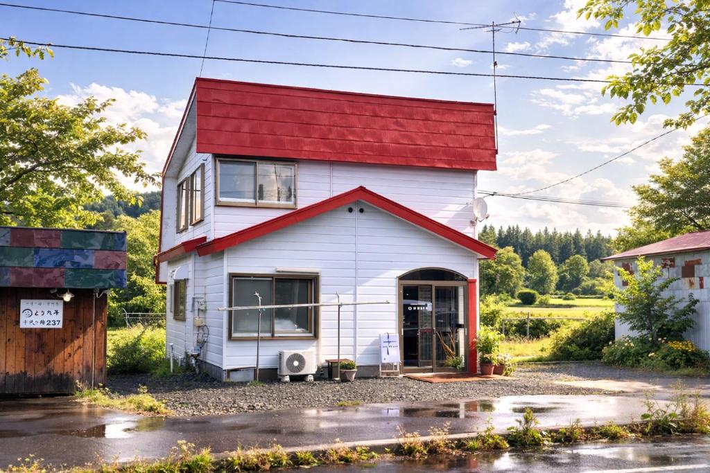 a house with a red roof with a driveway at My STAGE in Asahikawa
