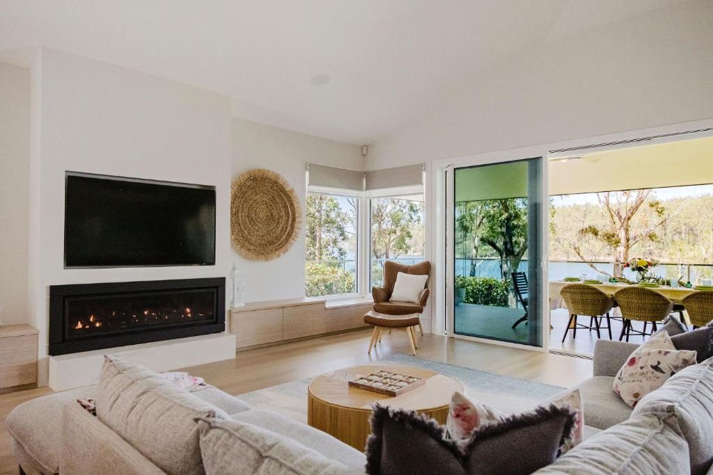 a living room with a couch and a fireplace at Lakeside House - Waterfront, Spacious, Pool Table in Yatte Yattah