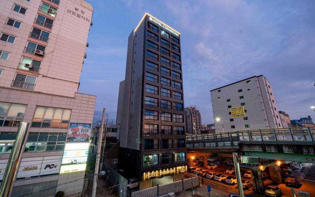 a tall building in the middle of a city at Hotel Corner Inn in Pyeongtaek
