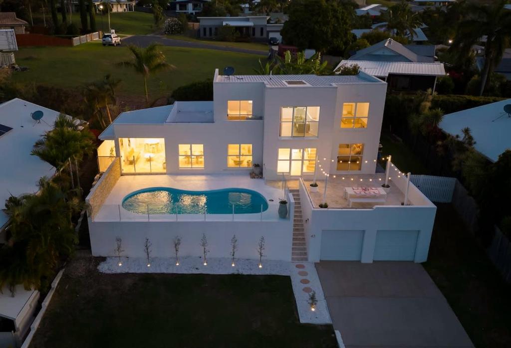 an aerial view of a house with a swimming pool at WhitsunStays - The Cyclades in Eimeo
