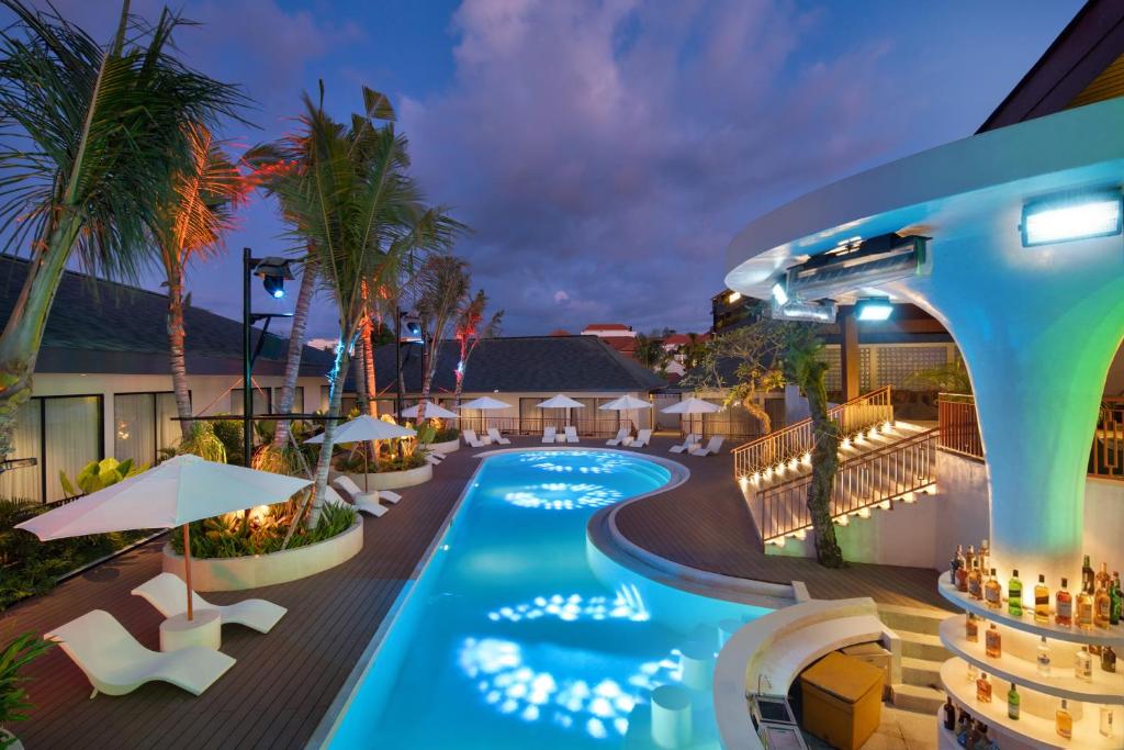 an image of a resort pool at night at Maha Resort Bali in Canggu