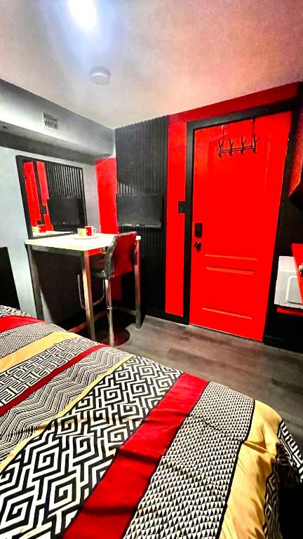 a room with a red door and a table and a desk at Luxury KIA Room E in Richmond Hill
