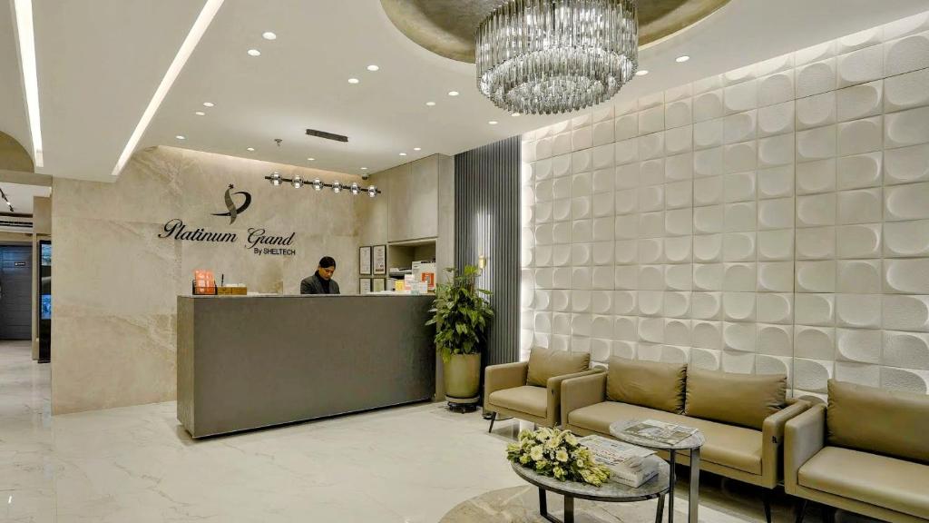 a lobby with couches and a counter in a store at Platinum Grand in Dhaka