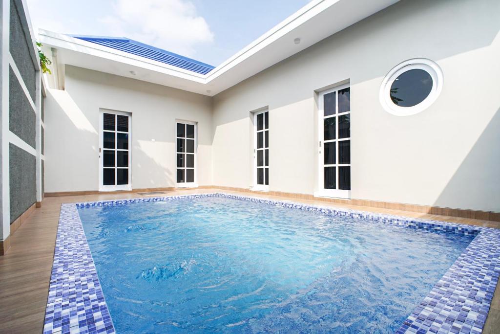 a swimming pool in the middle of a house at M Villa in Jetis