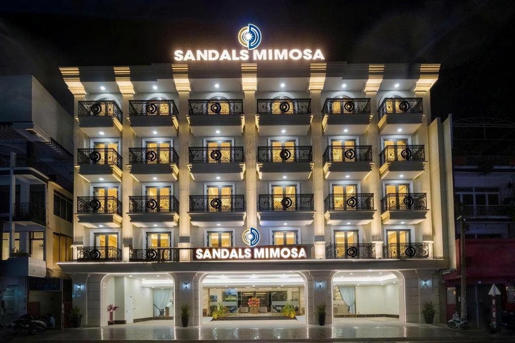 a hotel with a sign on the front of it at Sandals Mimosa in Da Lat
