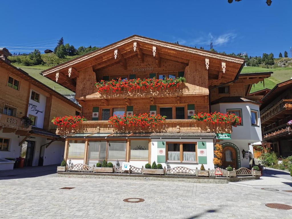 a building with flower boxes on top of it at Petererhof in Gerlos