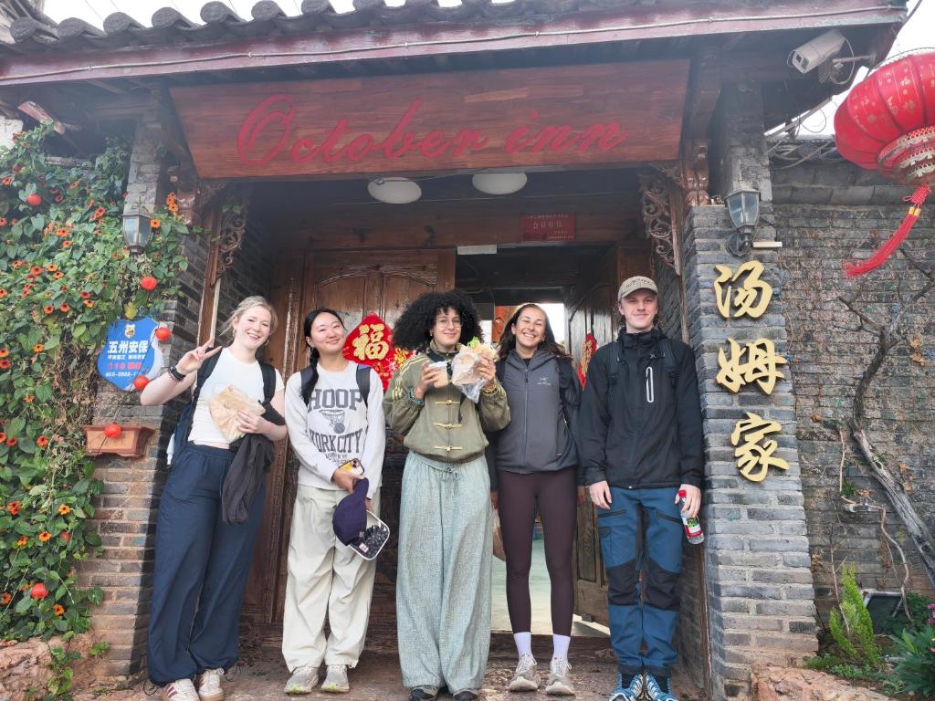 a group of people standing in front of a building at October Inn in Lijiang