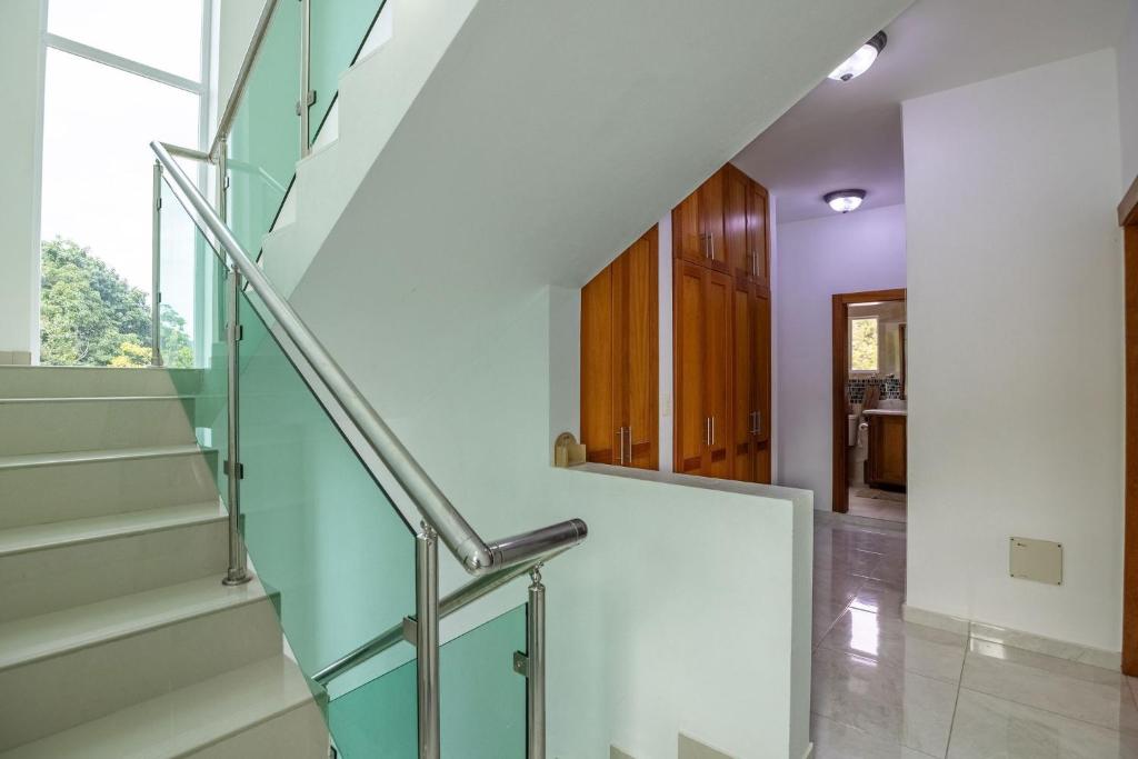 a staircase in a house with purple walls at Cozy home in puerto plata in San Felipe de Puerto Plata