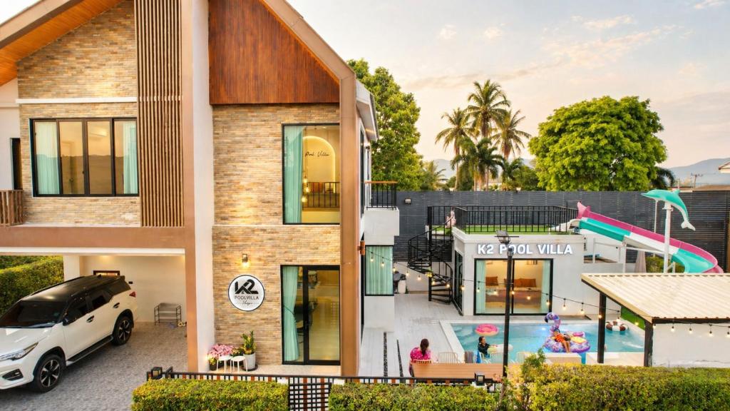 a house with a pool and a car parked outside at K2 Pool Villa Khaoyai in Ban Sap Setthi