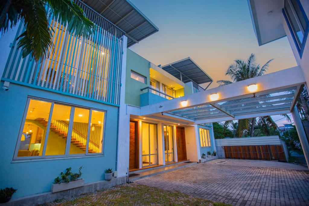 a blue house with a patio in front of it at Lovina Heights in Mount Lavinia