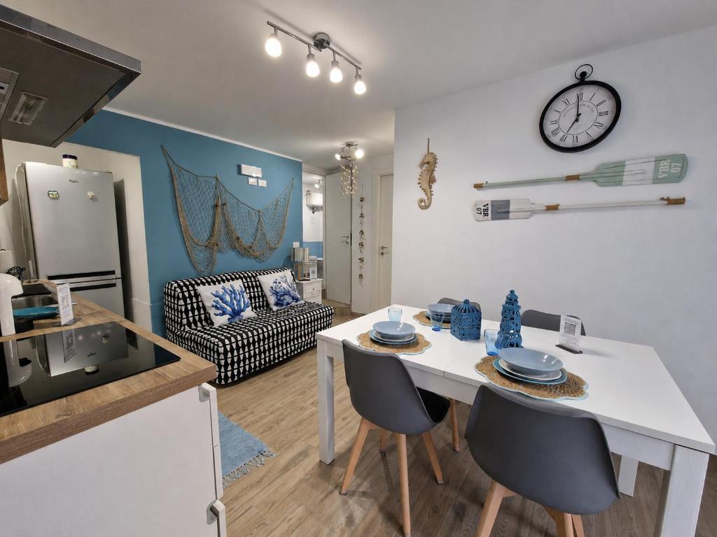a kitchen and living room with a table and chairs at La Rinascita HOUSE in Francavilla al Mare