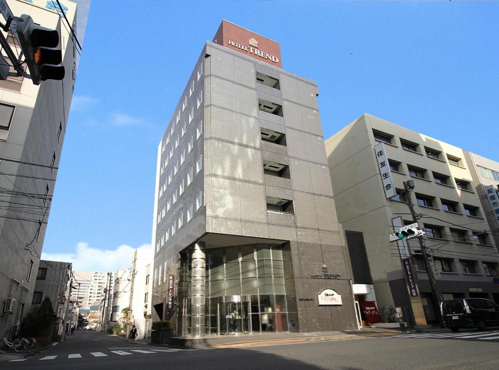 a tall building with a sign on top of it at Hotel Trend Funabashi in Funabashi