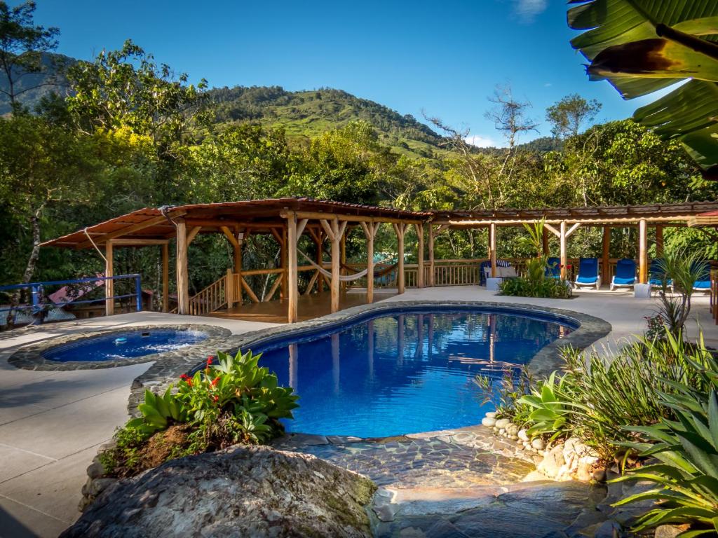 a pool with a gazebo and a resort at Rio Chirripo in Rivas