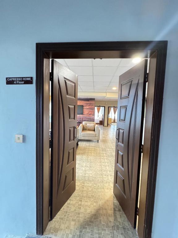 an open door leading into a room with a couch at Capresso Homes 4 in Islamabad