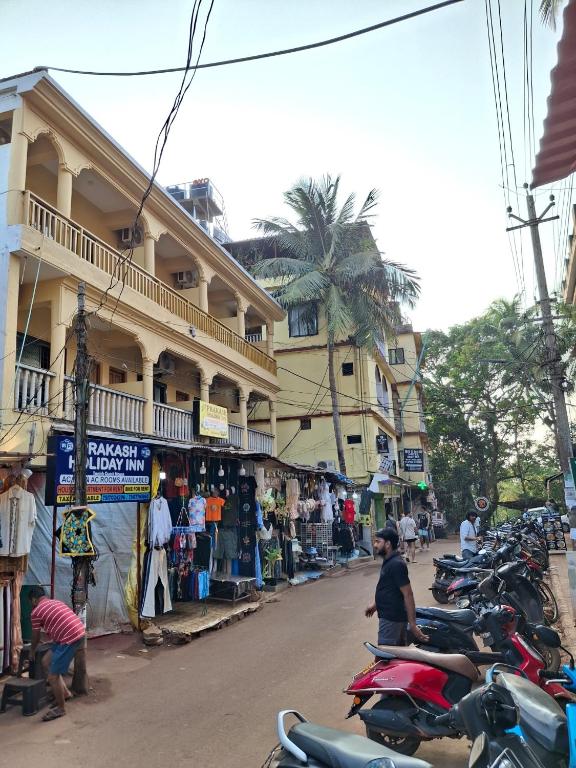 a row of motorcycles parked on the side of a street at Prakash Holiday Inn in Arambol