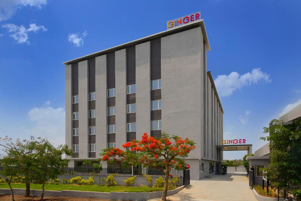 a hotel building with a sign on the side of it at Ginger Hyderabad Genome Valley in Turkapally