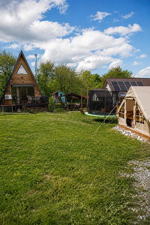 a yard with a house and a tent at Cabana A-frame Moon Predelut in Predeluţ